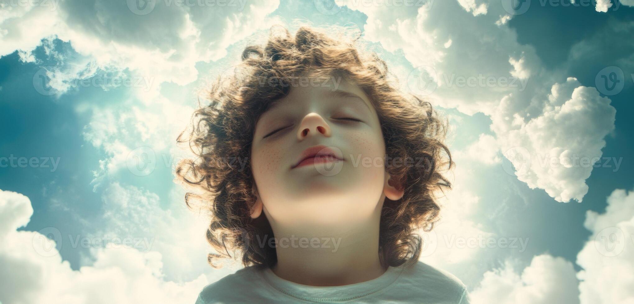 A young boy is looking up at the sky photo
