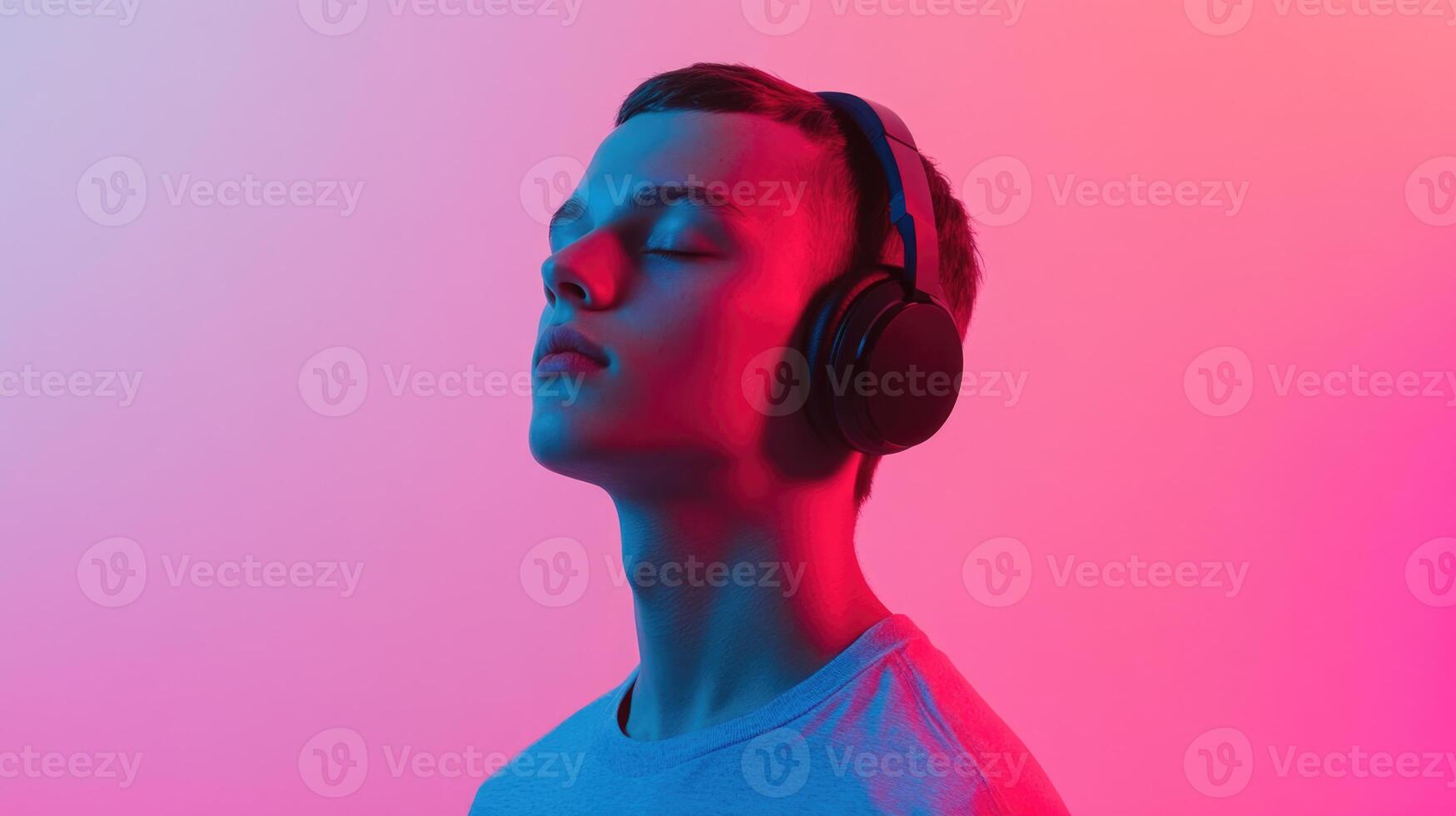 A man wearing headphones and looking up photo