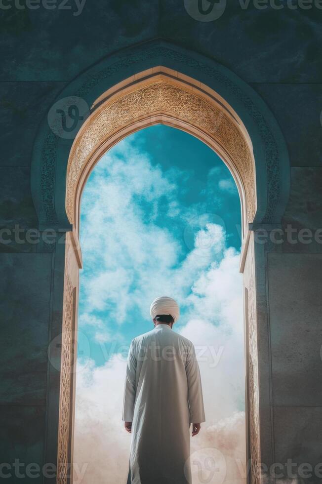 A muslim man standing in front of an archway photo
