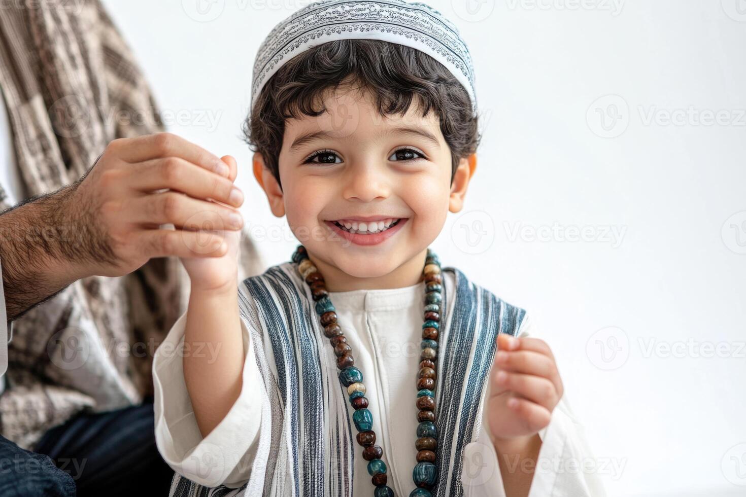 A little boy in a traditional muslim outfit photo