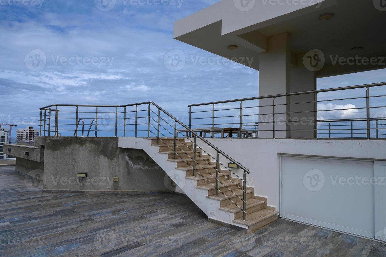 Elegant rooftop terrace with elegant stairs and modern architecture in a coastal city photo