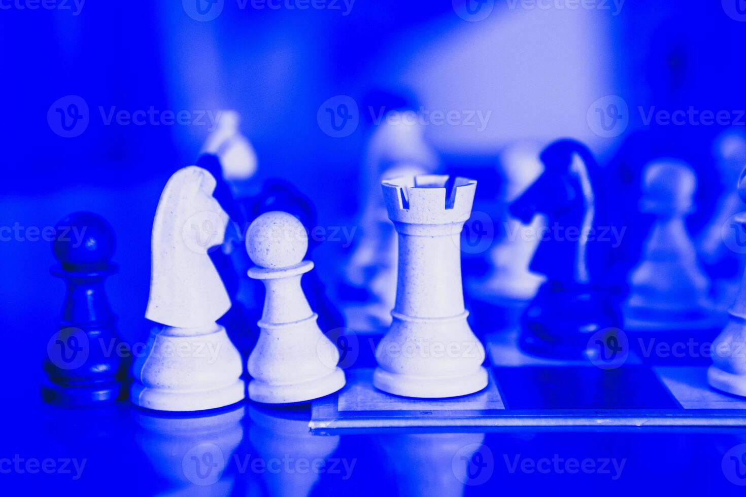Chess game setup with pawns and knights in position, ready for a strategic battle photo
