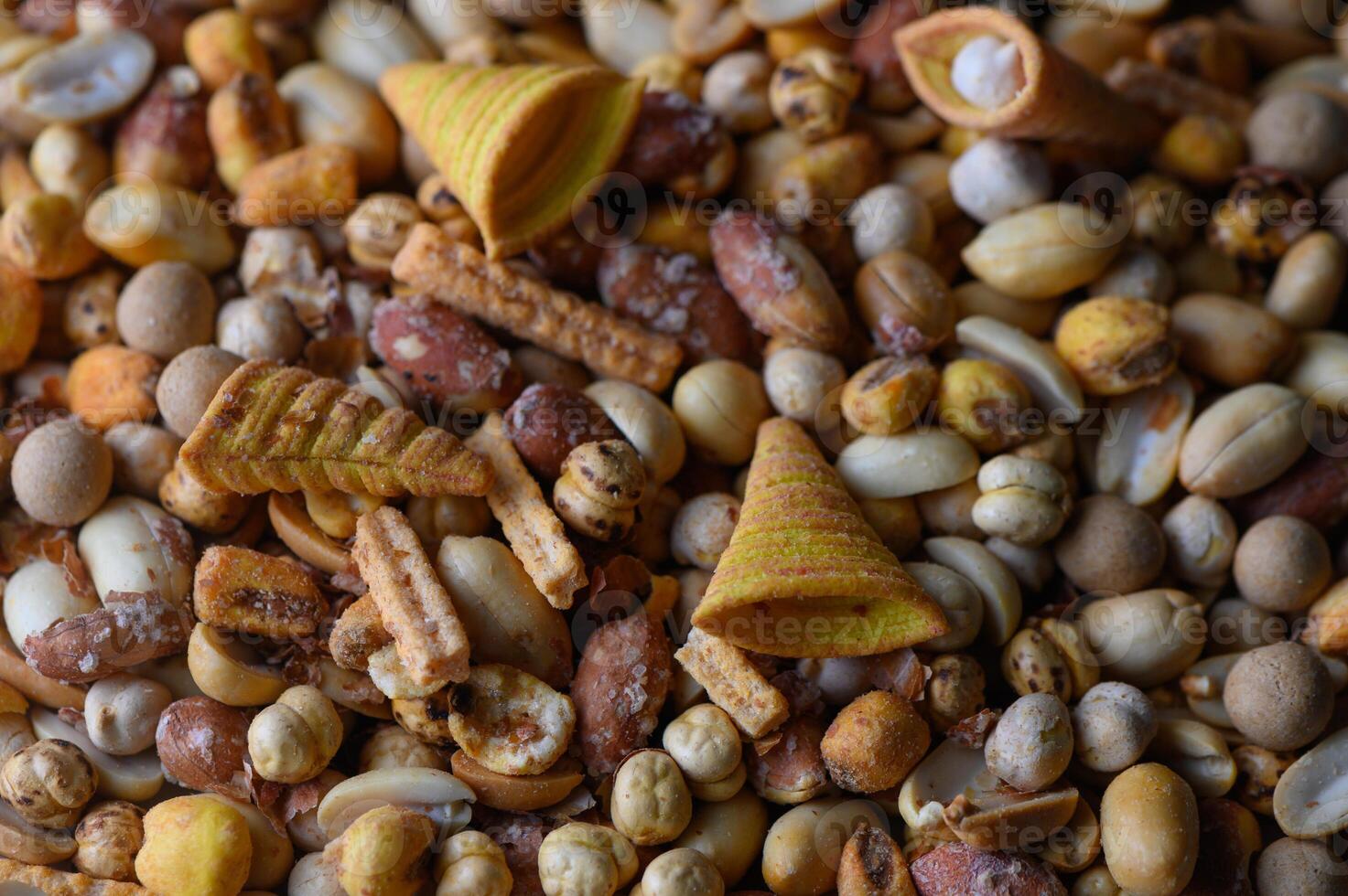Variety of colorful snacks displayed in a vibrant and lively arrangement on a rustic surface photo