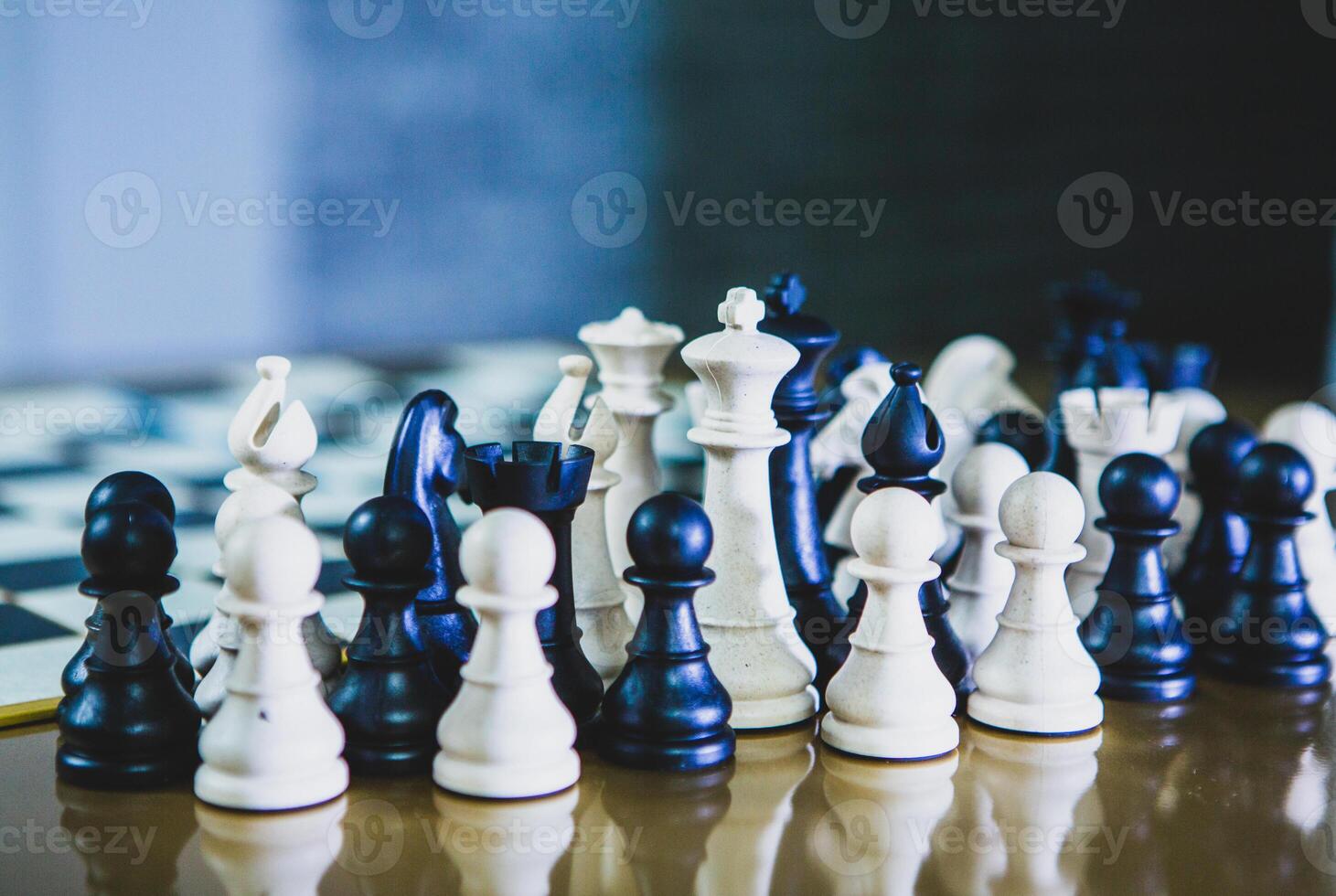 Classic chess game in progress with wooden chess pieces on a board, symbolizing strategy, intelligence, and competition photo