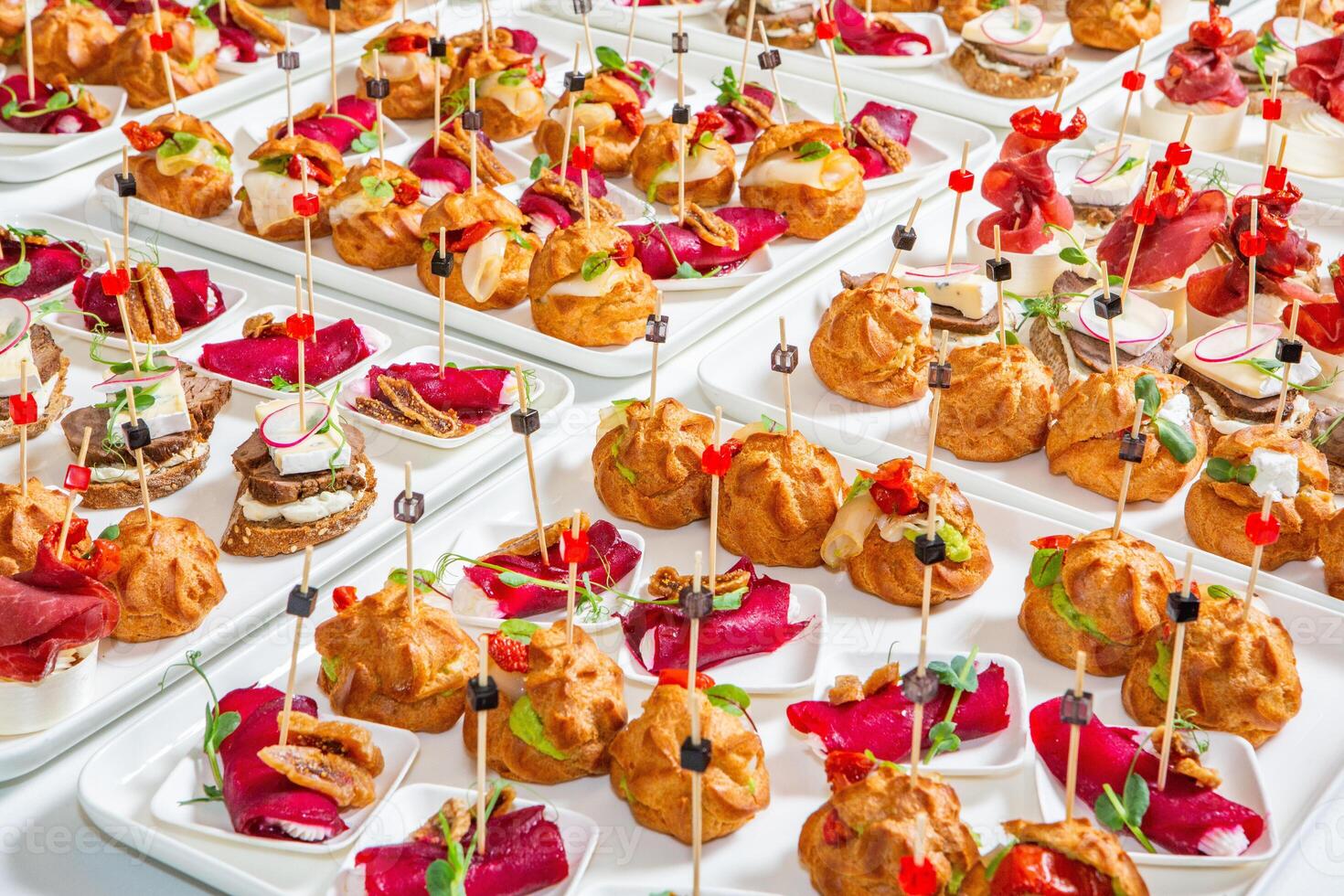 Catering buffet or service with different snacks, appetizers and canapes on a table. Variety of Freshly Prepared Catering Food for an Event. photo