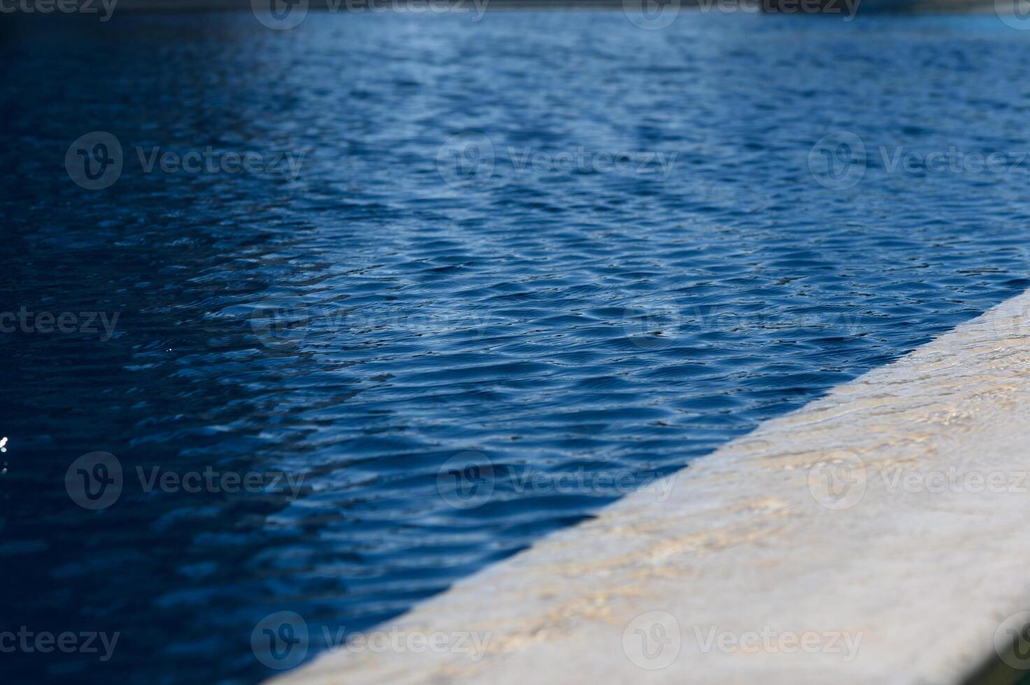 Tranquil water ripples create calming reflections in a serene pool under a clear sky photo