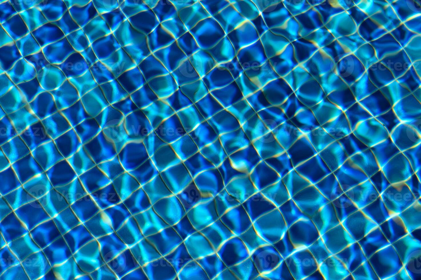Dazzling patterns of sunlight dancing on a shimmering pool surface during a bright summer day photo