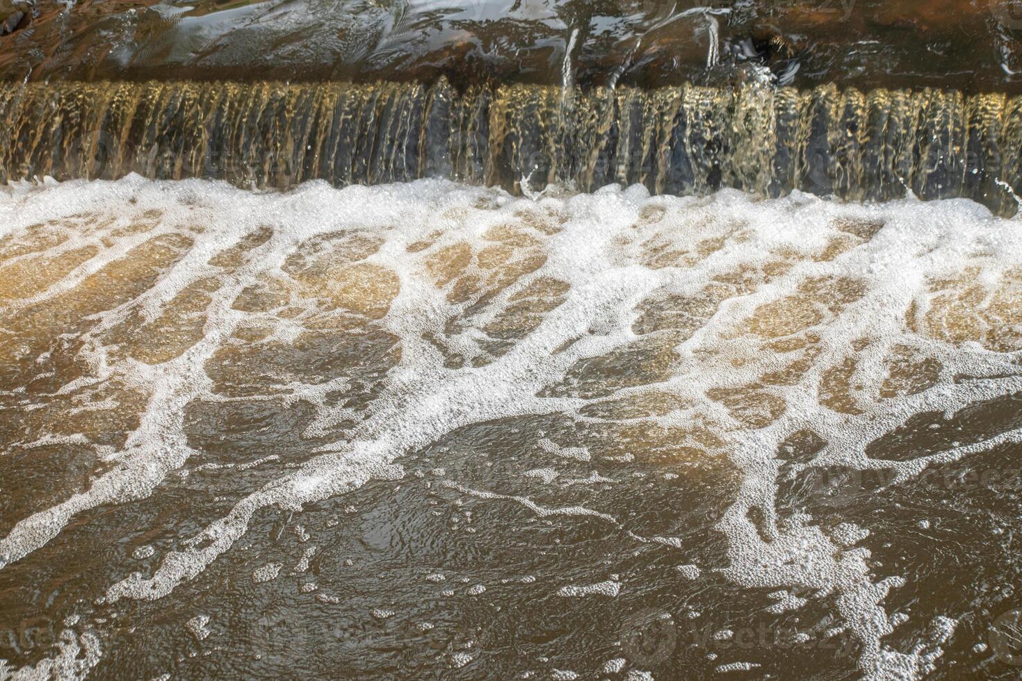 Polluted Water Flowing Through Urban Area photo