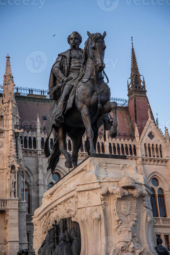 vertical Equestrian statue of Gyula Andrassy in front of Hungarian Parliament Building in Budapest photo