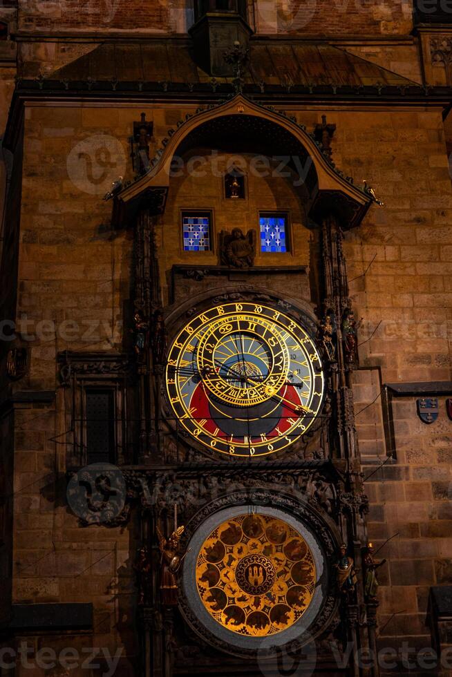 Astronomical Clock of Prague shining during night in Czech Republic photo