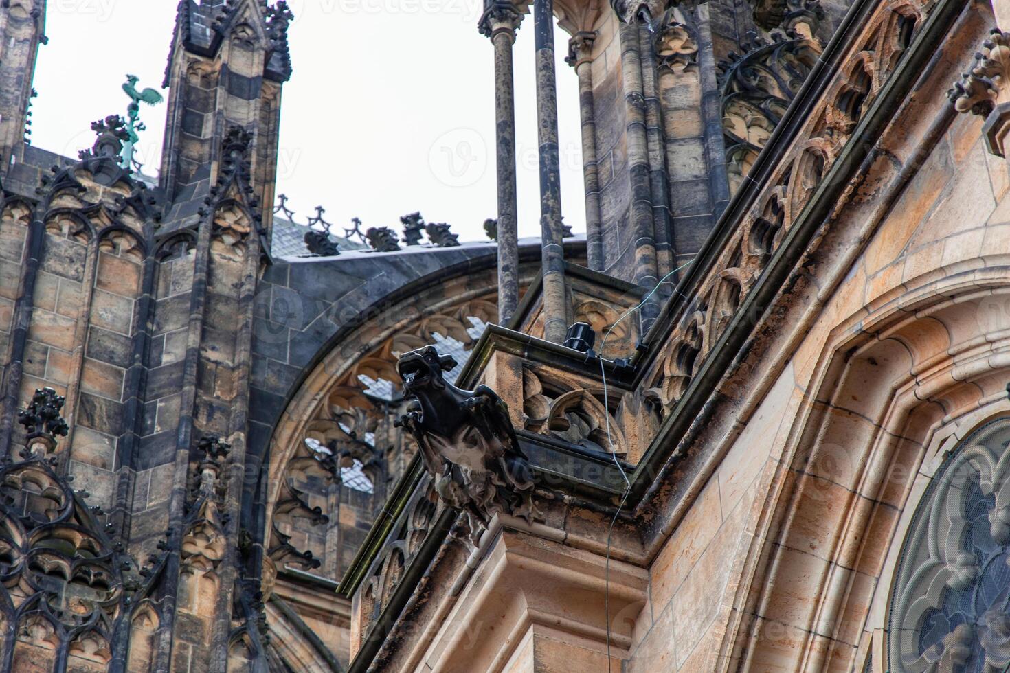 Gargoyle overlooking Prague from St. Vitus Cathedral roof photo