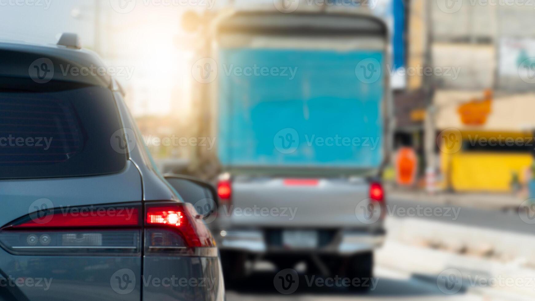 Luxury of grey car open light brake on the asphalt road. Traffice in the city. Blurred of other cars on the road in day time. photo