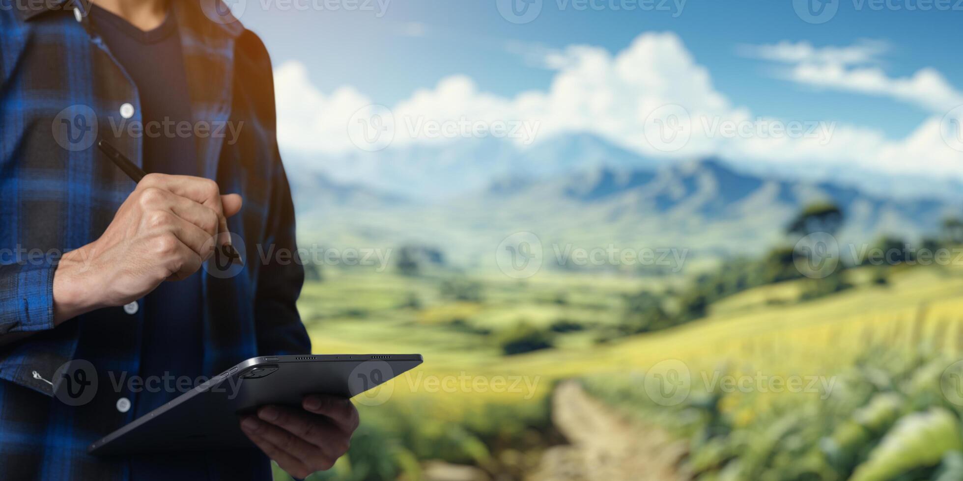 Man Using Tablet in Scenic Mountain Landscape with Clear Sky photo