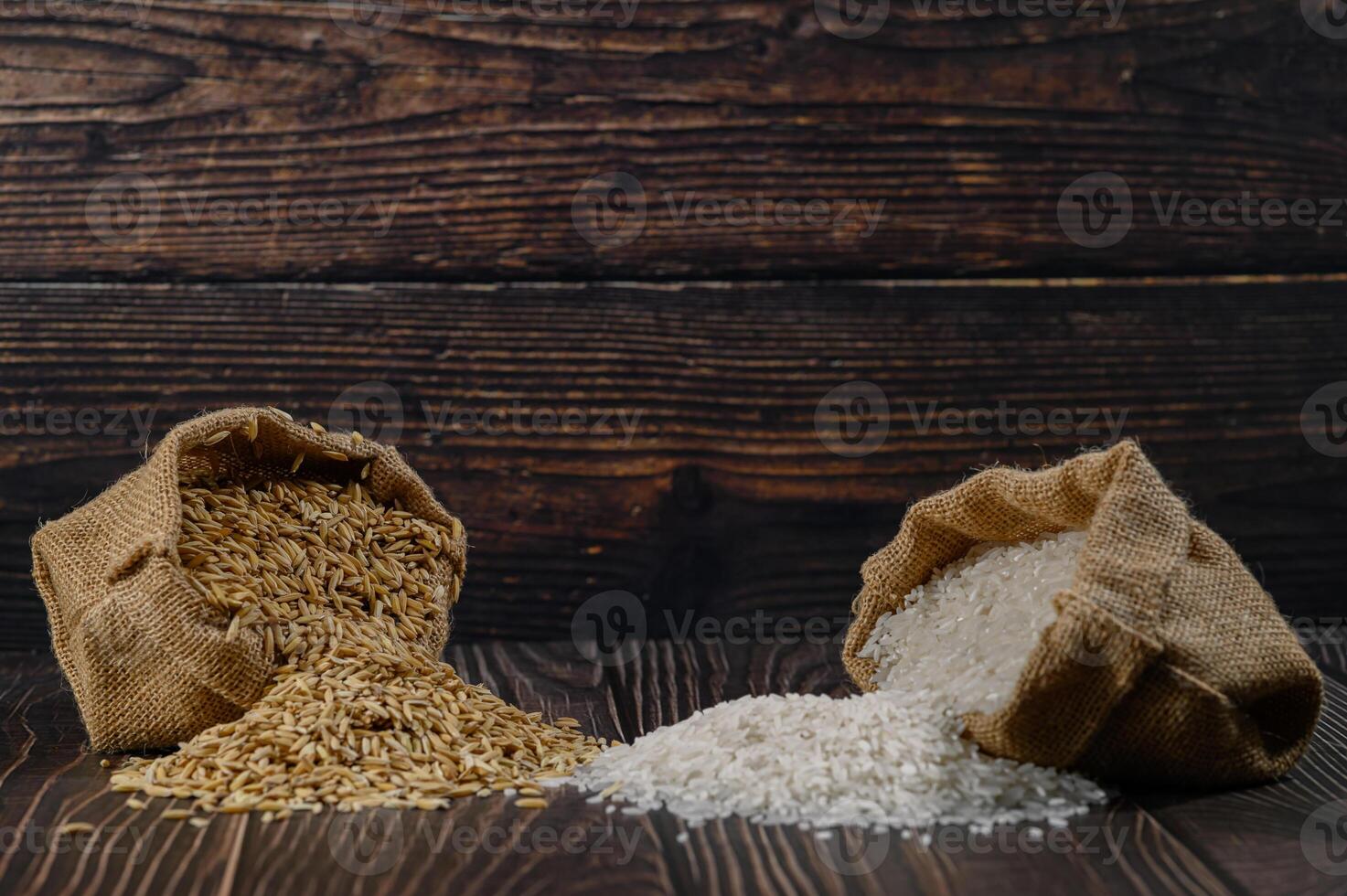 Raw and Processed Rice in Burlap Bags on Rustic Wooden Background photo