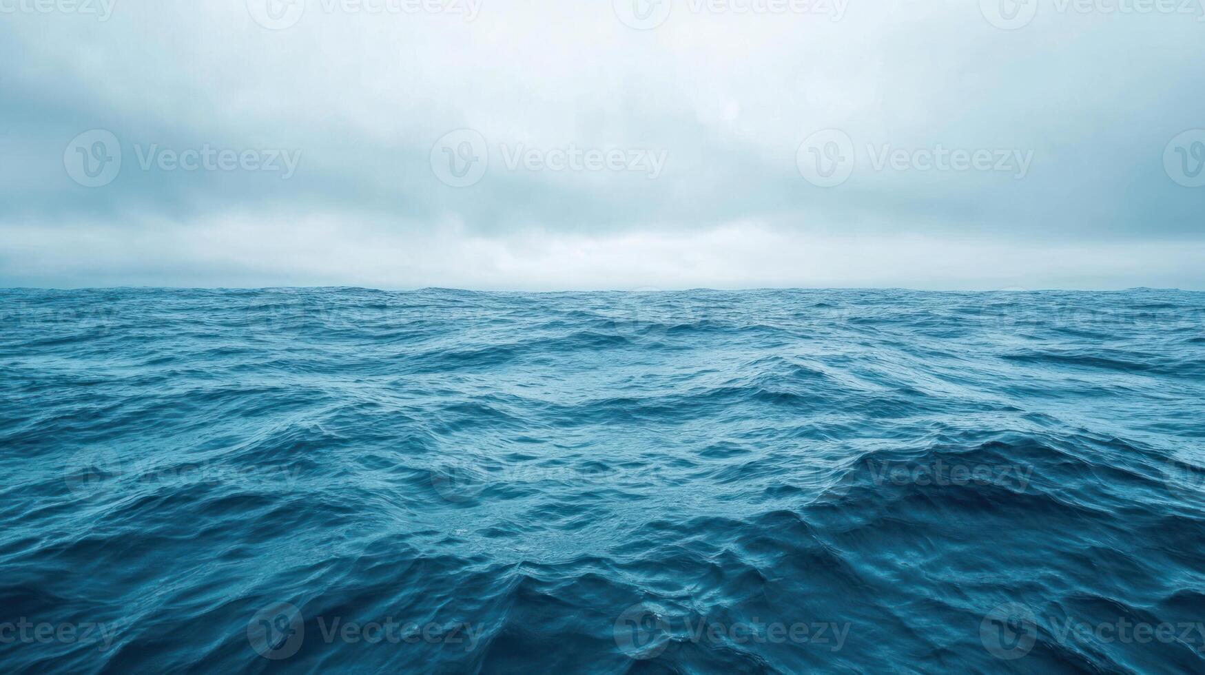 Distant View of Rippling Ocean Waters Under Cloudy Sky photo