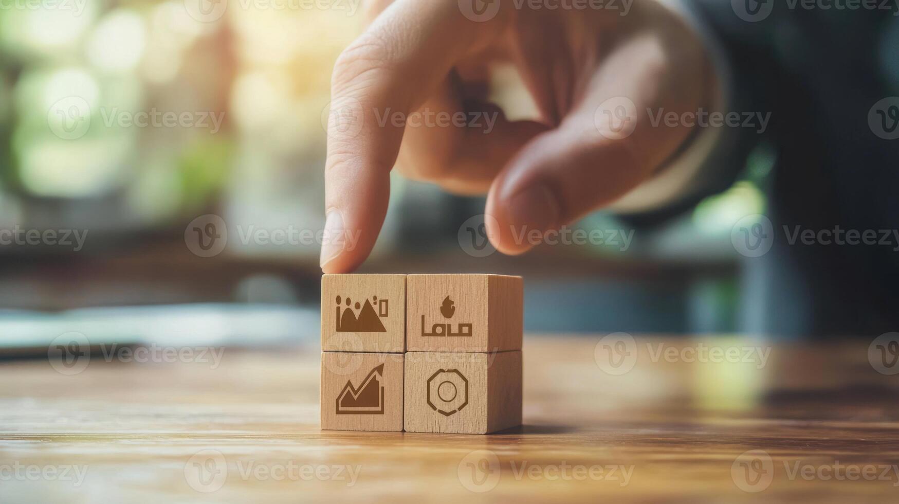 Hand Pointing at Wooden Blocks with Business Icons photo