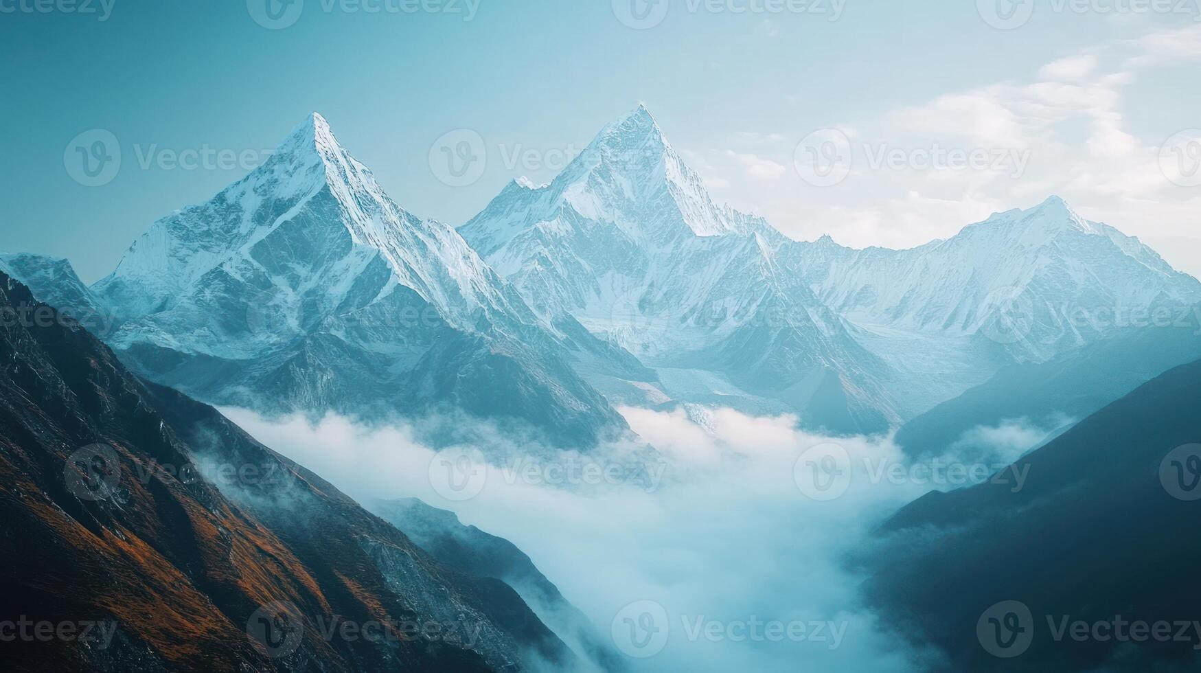 Majestic Snowy Mountain Peaks with Misty Valley photo