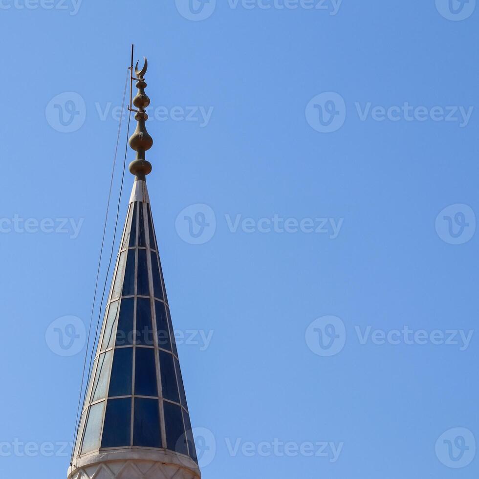 Mosque Minaret on a background of blue sky in Turkiye photo