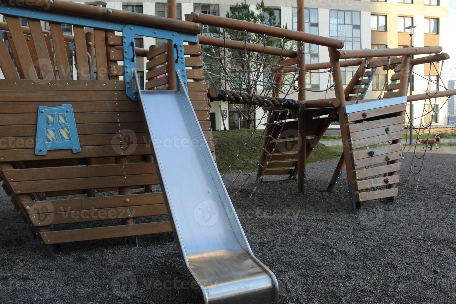 Metal slide on the playground. Modern courtyard photo