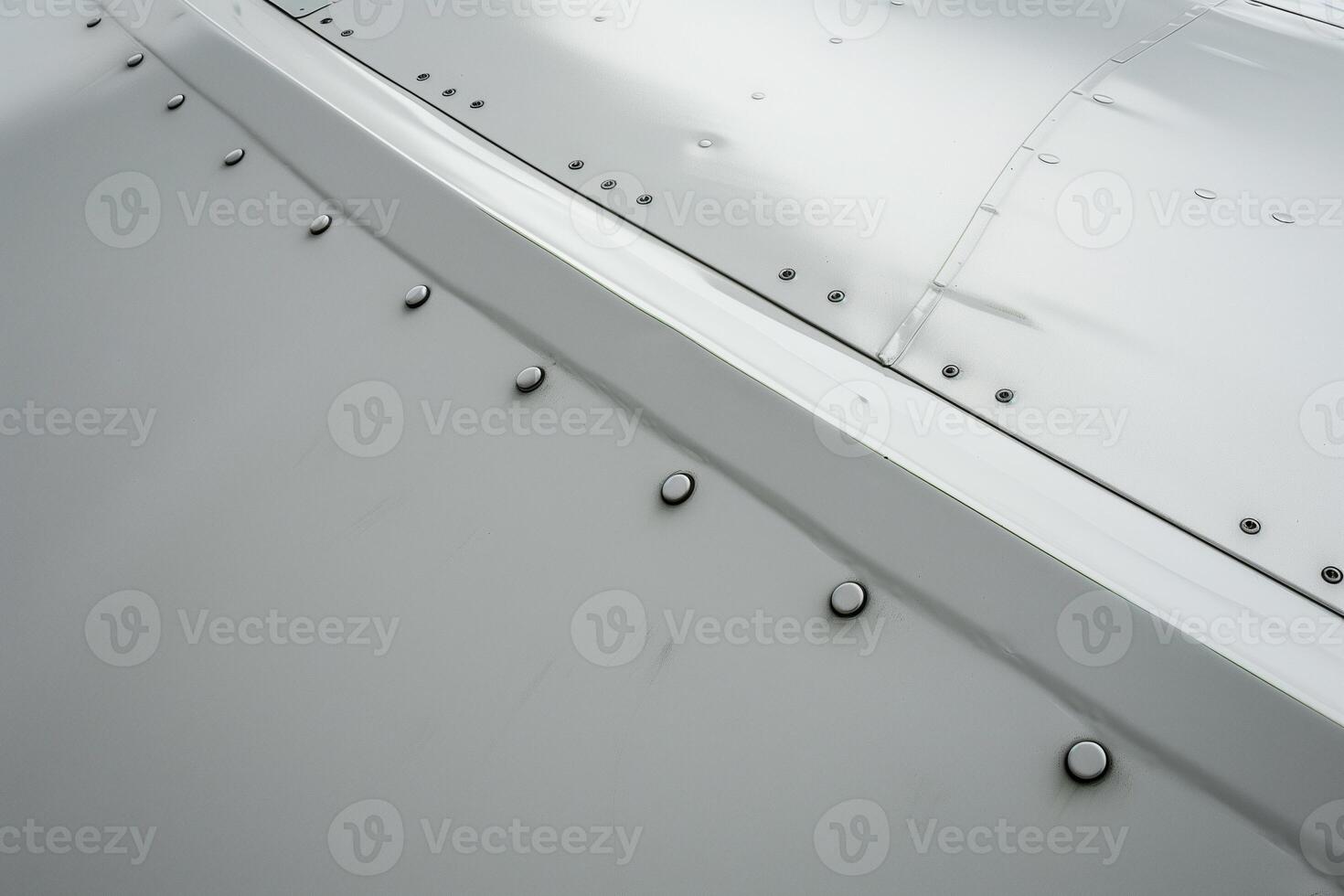 Close-up view of a jets riveted aluminum tail showcasing textured metal and smooth matte white paint photo
