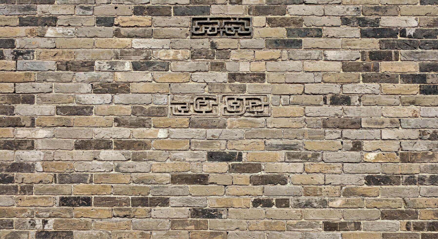 A brick wall with a clock on it photo