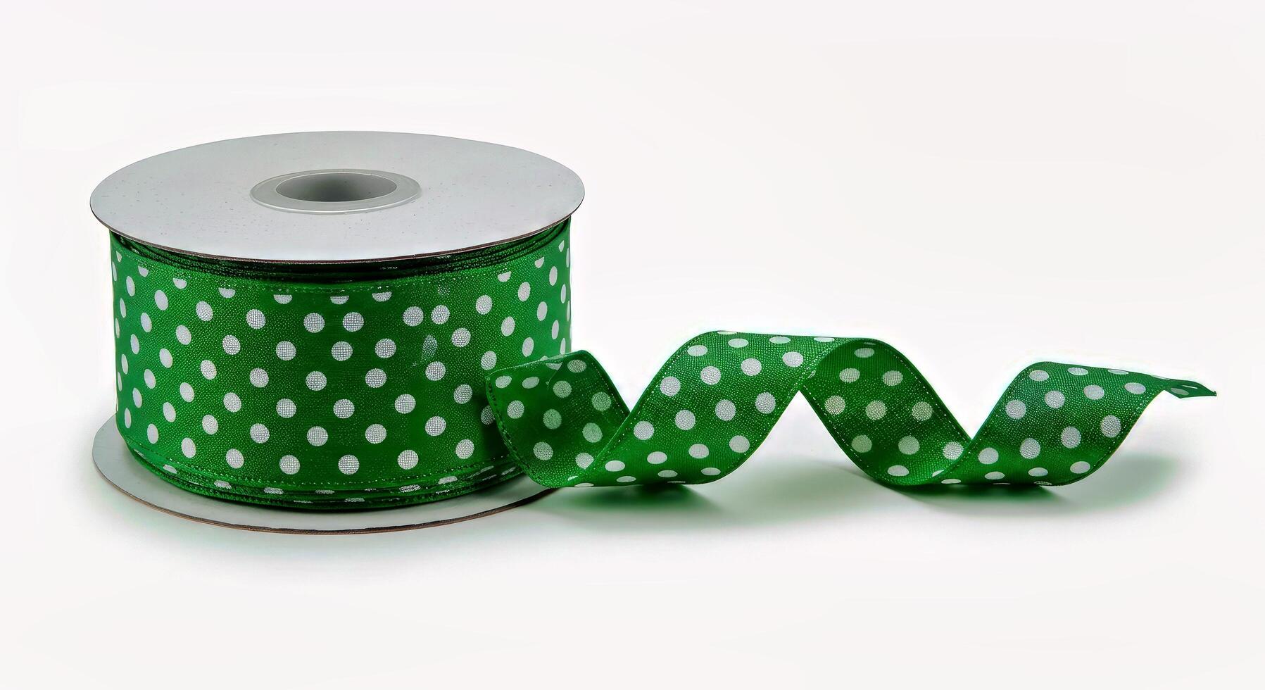 A spool of green polka dot ribbon with white polka dots photo