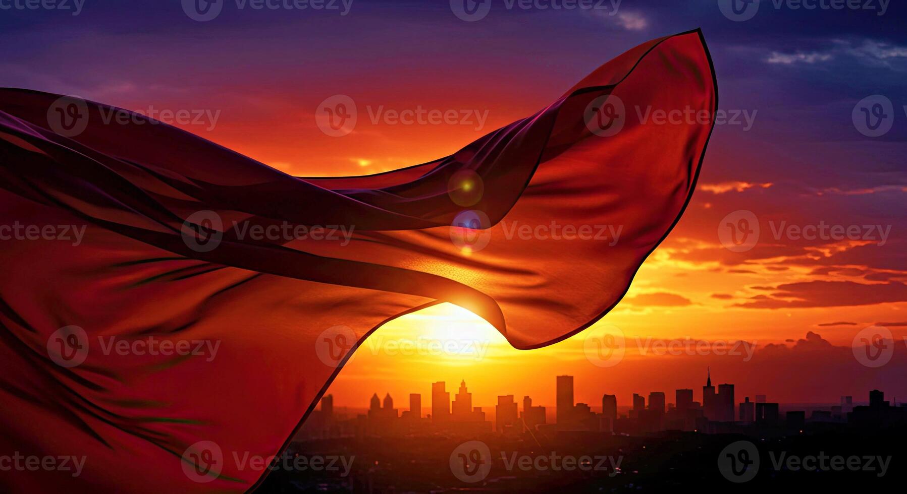 A red flag flying in the wind at sunset photo