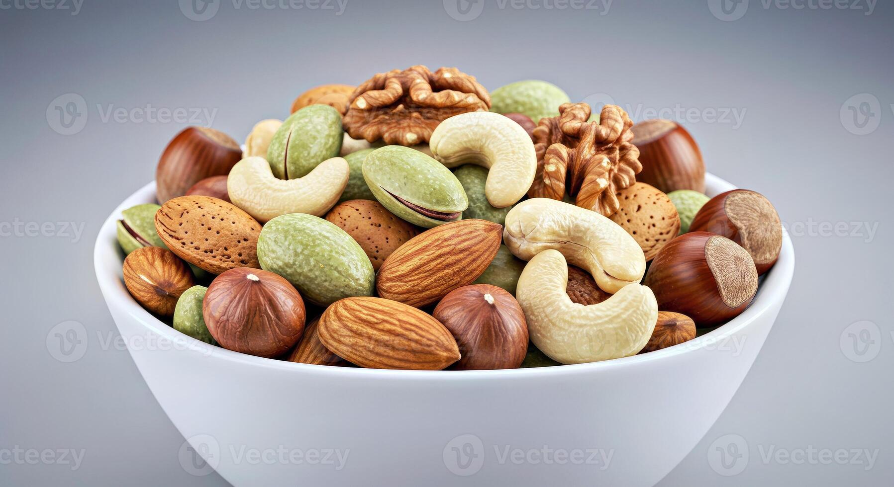 A bowl of mixed nuts on a gray background photo