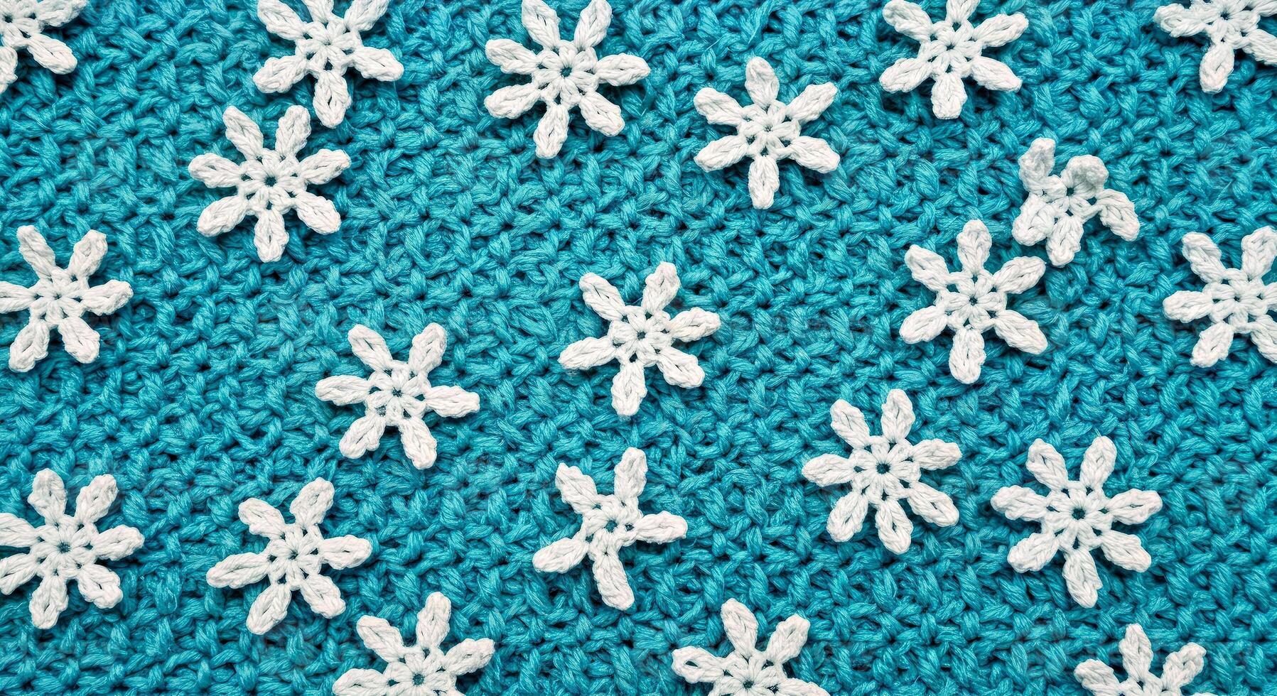 A close up of a knitted snowflake pattern on a blue background photo