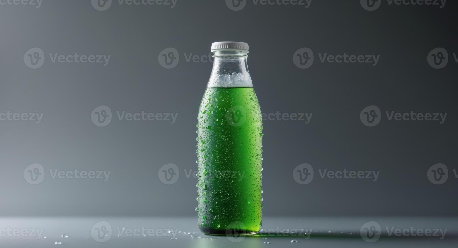 A bottle of green soda with water on a table photo