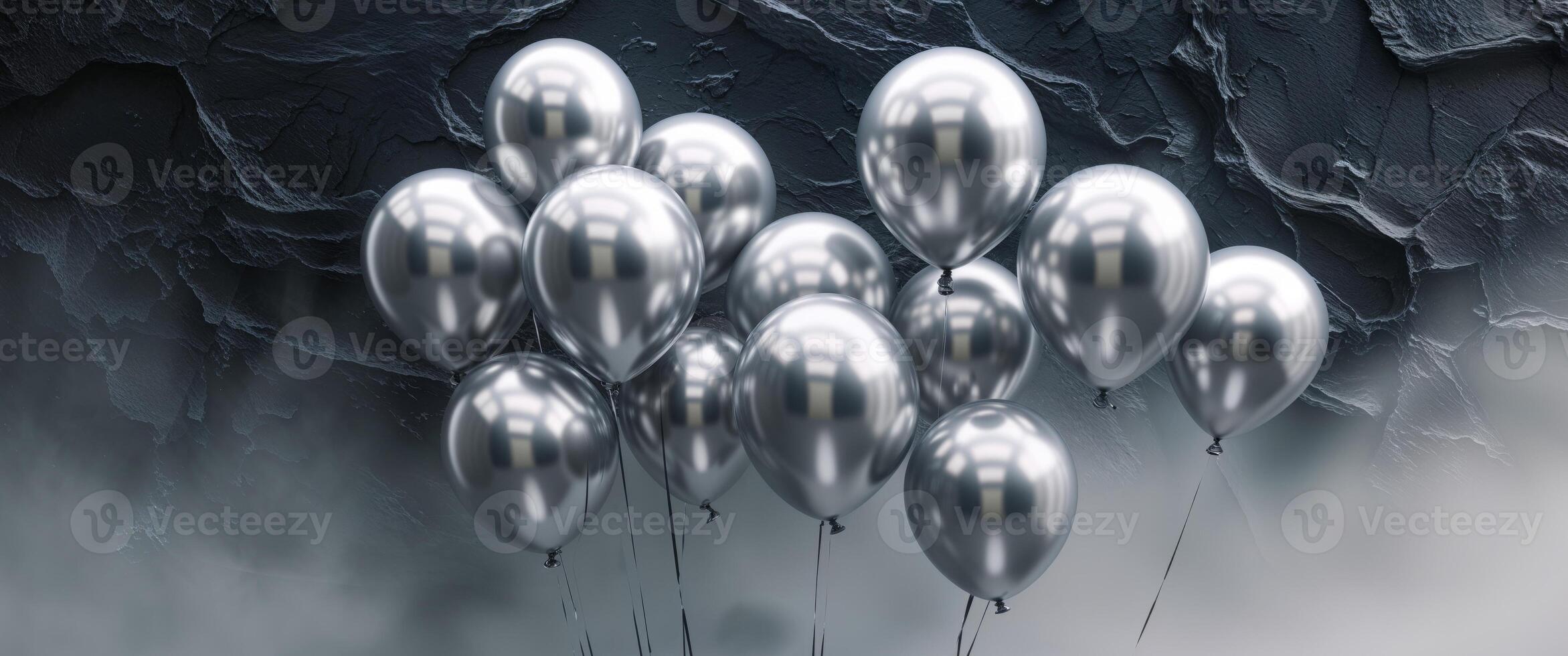 Silver balloons floating in the air on a dark background photo