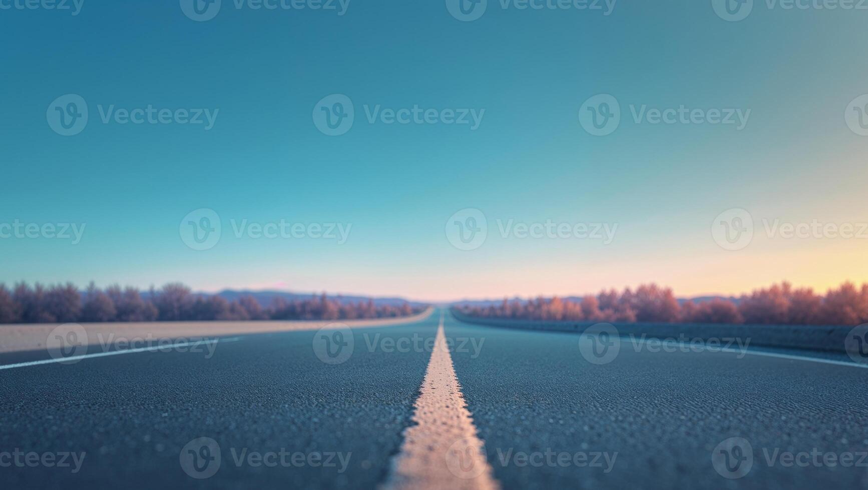 Empty paved road stretching to a bright sky photo