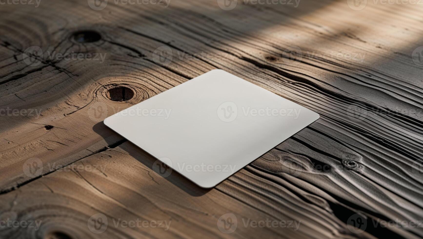 Blank Stationery Design Featuring a White Card on a Textured Wood Surface. photo