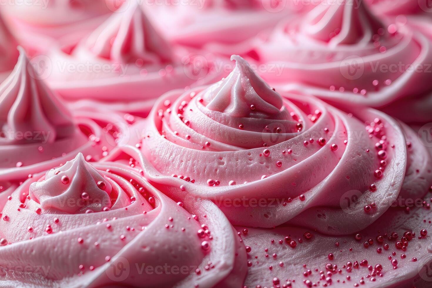 Pink frosting swirls with pink sprinkles on a cake photo