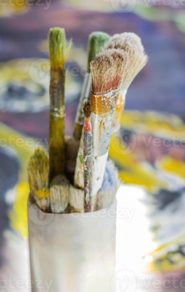 Set of paint brushes on oil canvas photo