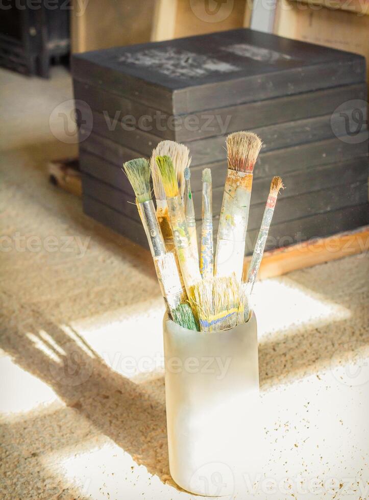 Paint brushes set in front of canvas photo