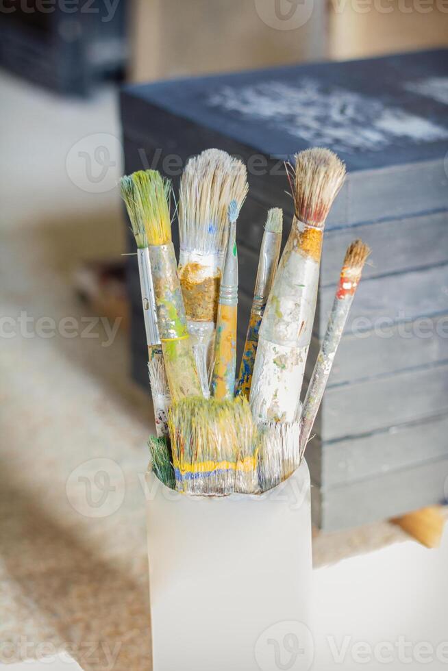 Paint brushes in front of canvas photo