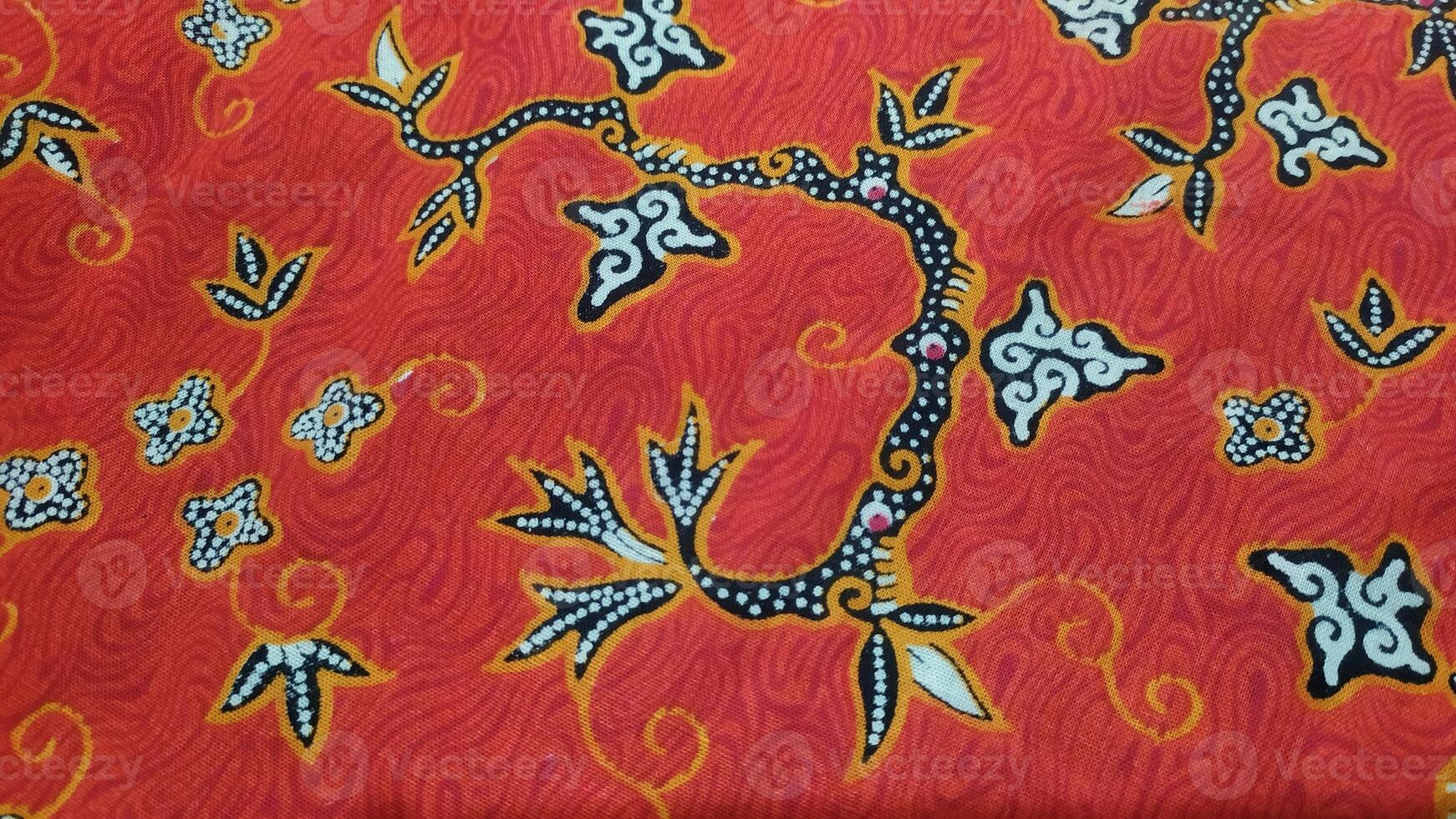 a red and black fabric with a floral design. photo