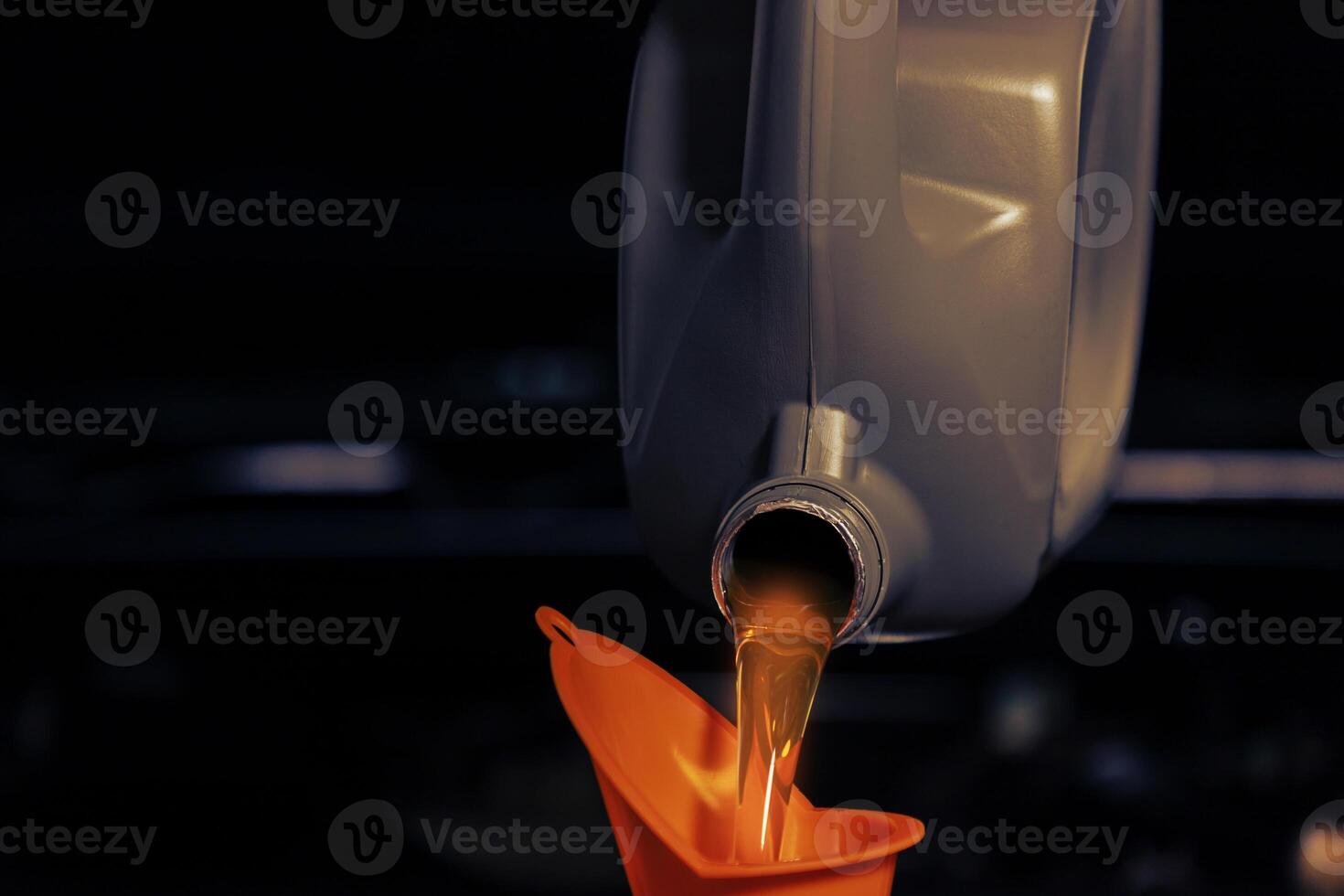 Car mechanic, oil change or fuel from a bottle of engine lubricant, service industry, automobile and engine repair technology.. photo