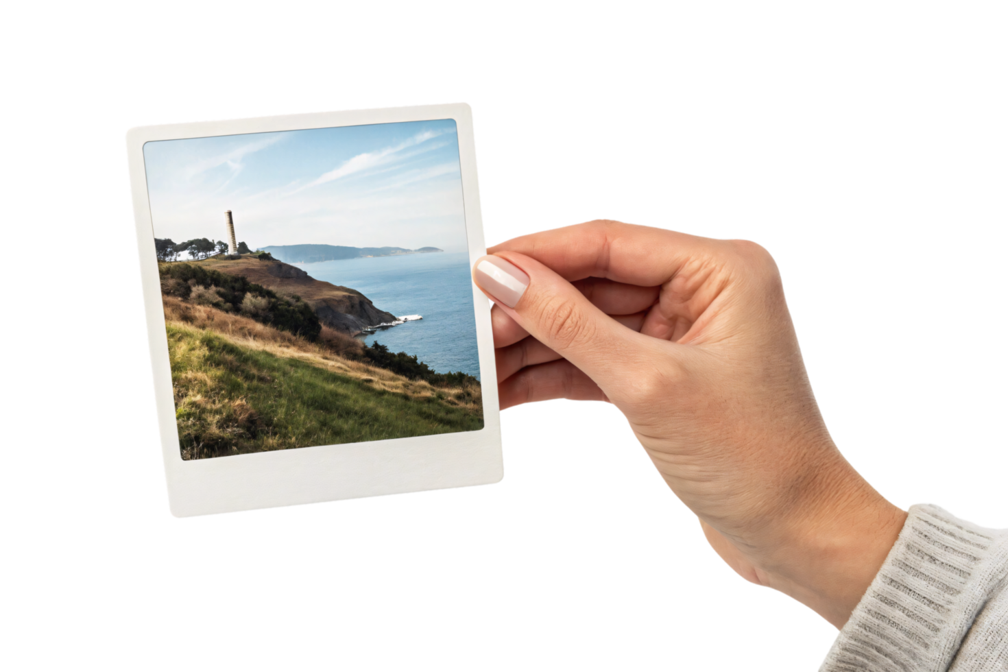 A hand holds a slide featuring a scenic coastal landscape. It depicts a lighthouse on a grassy hill overlooking the sea and a serene sky png