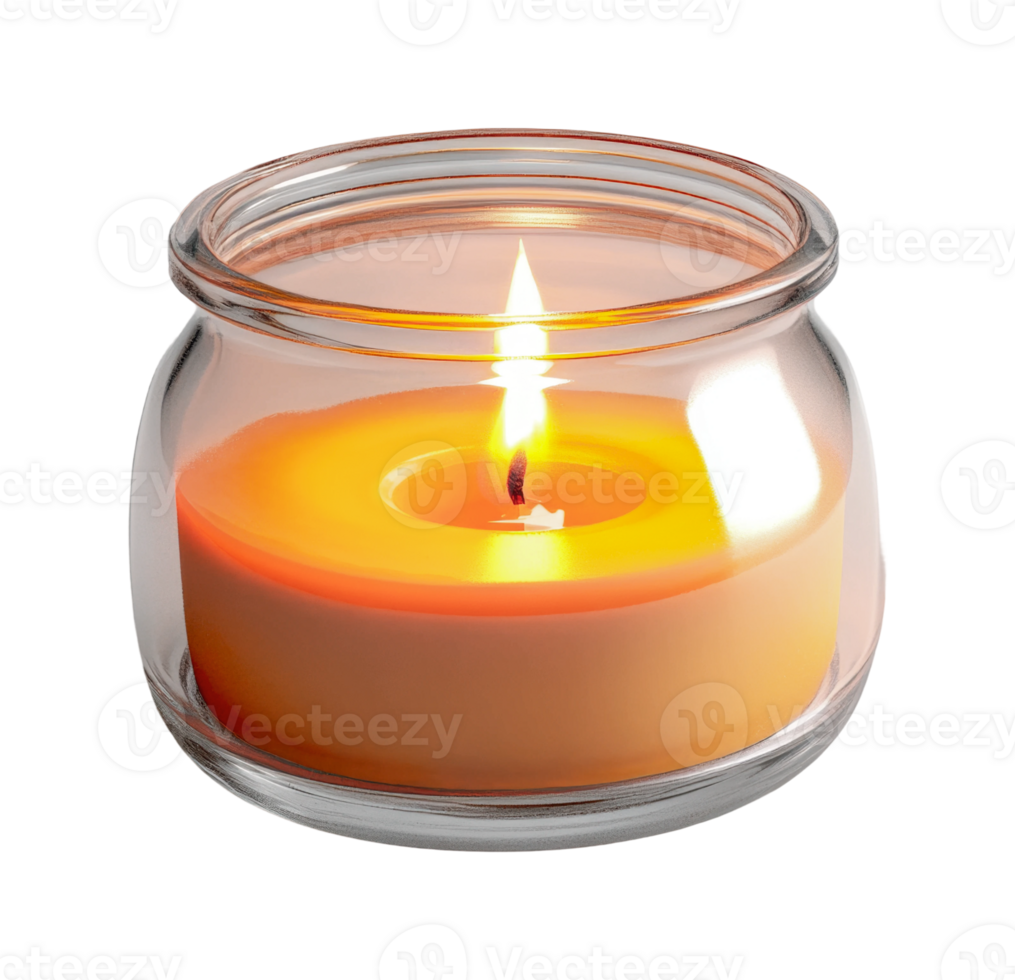 Lit orange scented candle in glass jar with warm glow, cut out png
