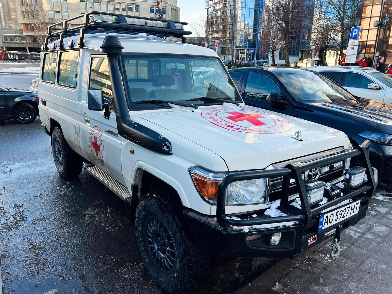 Kyiv, Ukraine - March 04, 2025- Emergency Toyota Land Cruiser Red Cross medical vehicle parked on an urban street on a winter day photo