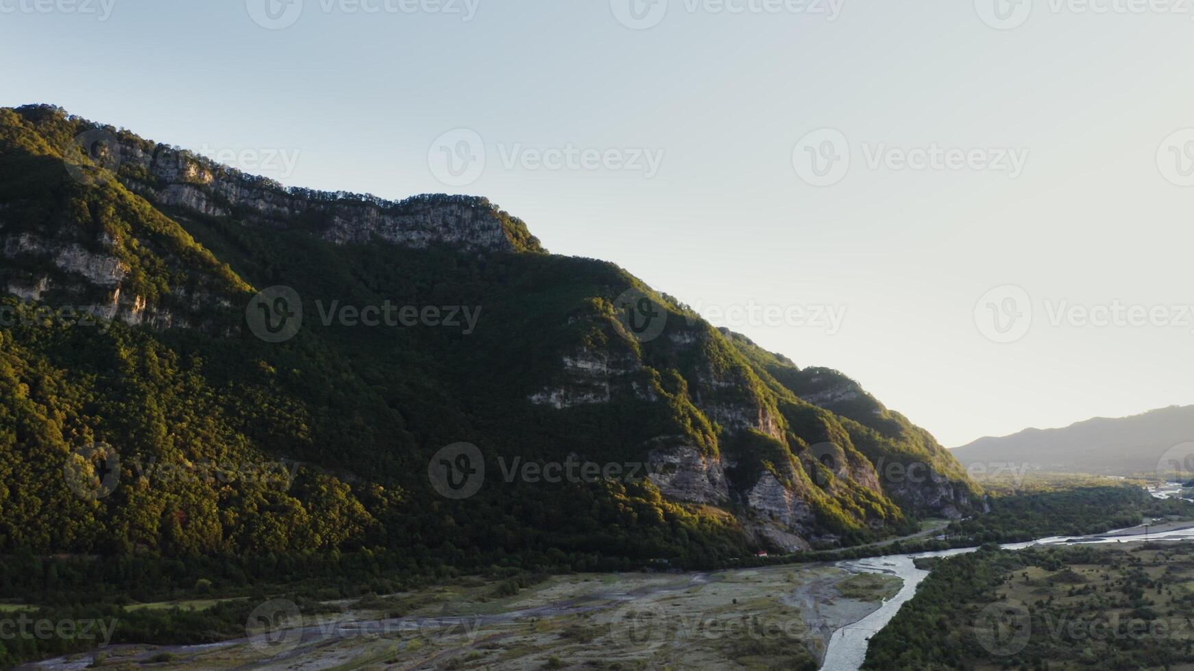 A valley surrounded by mountains and river photo