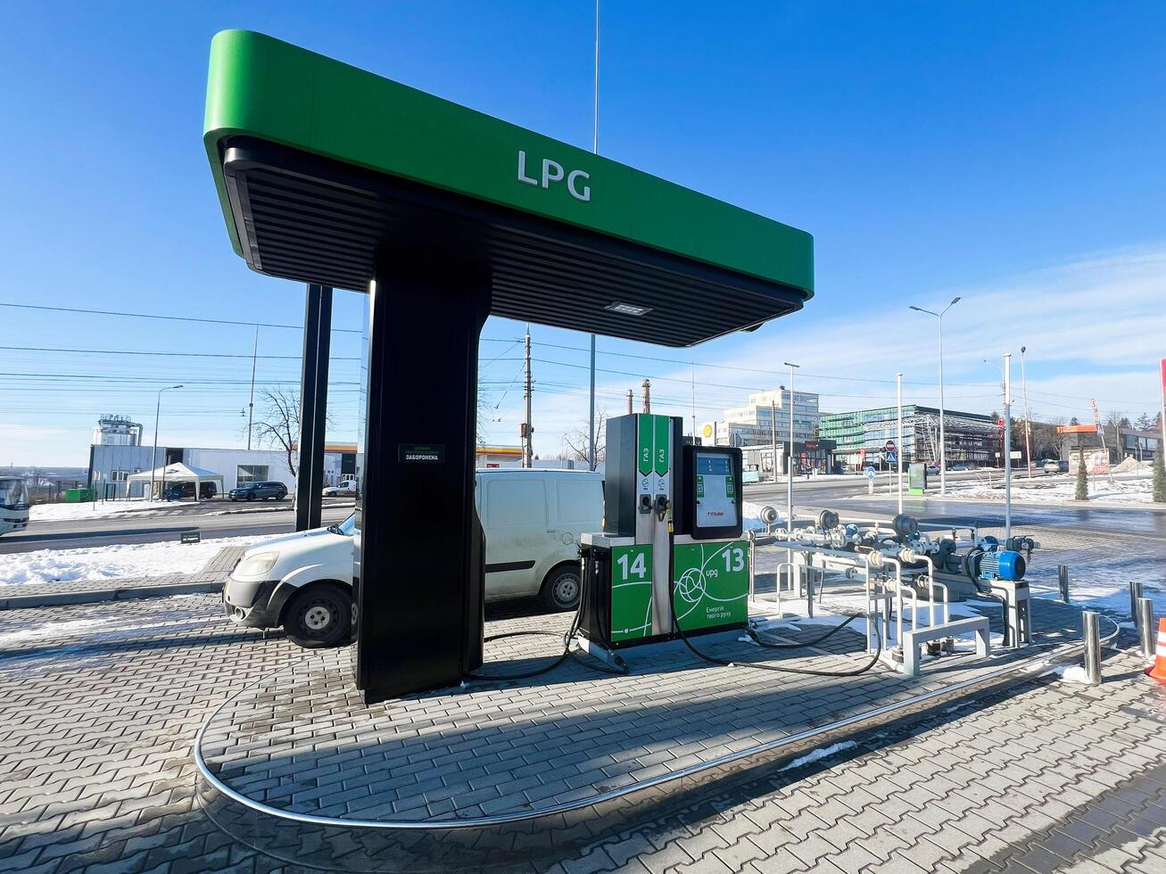 Kyiv, Ukraine - March 04, 2025- Modern LPG refueling station with visible vehicles on a clear winter day photo