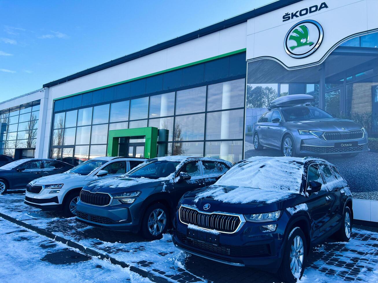Kyiv, Ukraine - March 04, 2025- Showroom Display of Skoda Cars in Winter with Snow-Covered Vehicles photo