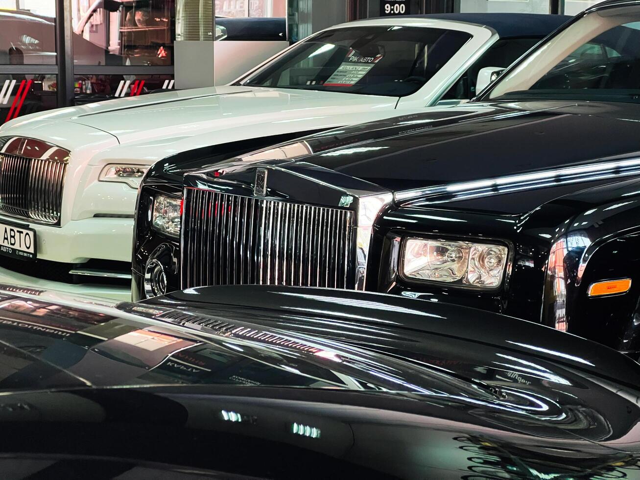 Lviv, Ukraine - February 12, 2025- Luxury Rolls-Royce cars showroom with a focus on elegant black and white vehicles photo