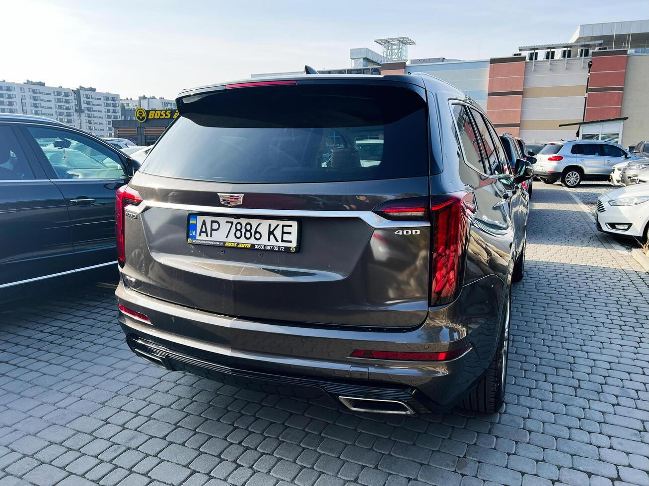 Lviv, Ukraine - February 12, 2025- Luxury Cadillac XT6 SUV in parking lot on sunny day surrounded by other vehicles photo