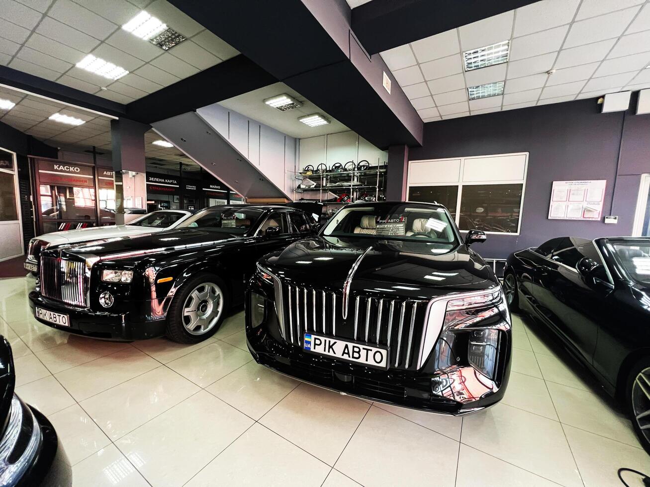 Lviv, Ukraine - February 12, 2025- Luxury cars showcased in an elegant showroom with stylish interior lighting photo
