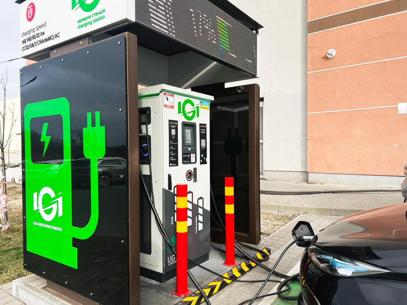 Lviv, Ukraine - February 12, 2025- Electric vehicle charging station with Renault Zoe car connected in outdoor setting photo
