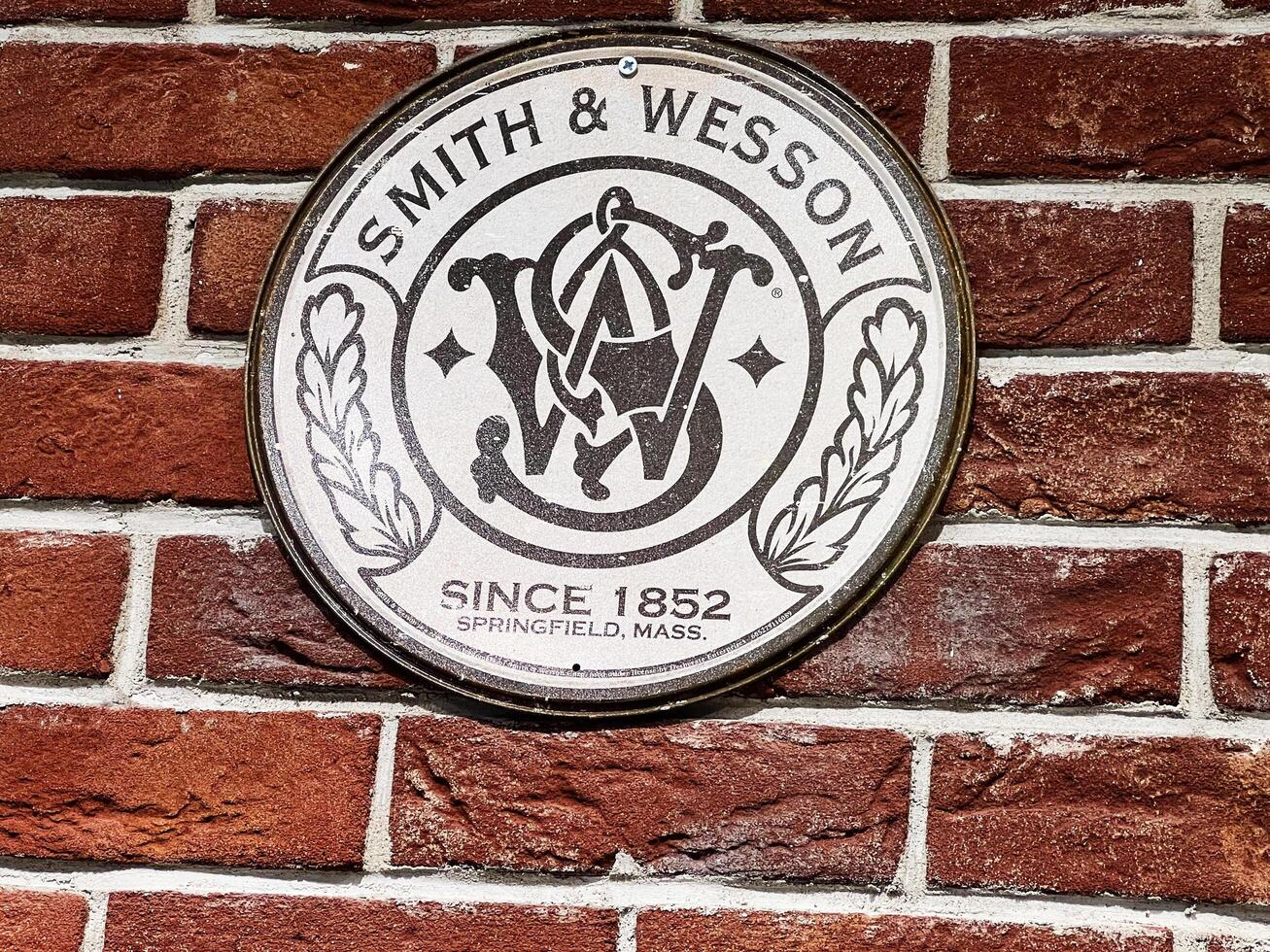 Lviv, Ukraine - February 13, 2025- Smith and Wesson emblem displayed on a red brick wall background photo
